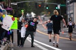 Supporters cheer on runners coming over the Sellwood Bridge during the Portland Marathon in Portland, Ore., Sunday, Oct. 6, 2019. The marathon's new route traveled through the Sellwood neighborhood.