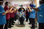 Margaret Keenan, 90, is applauded by staff as she returns to her ward after becoming the first patient in the UK to receive the Pfizer-BioNTech COVID-19 vaccine, at University Hospital, Coventry, England, Tuesday Dec. 8, 2020. The United Kingdom, one of the countries hardest hit by the coronavirus, is beginning its vaccination campaign, a key step toward eventually ending the pandemic.