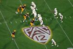 FILE - This Thursday, Aug. 29, 2019, file photo, shows the Pac-12 logo during the second half of an NCAA college football game between Arizona State and Kent State, in Tempe, Ariz. The Pac-12 has set Sept. 26 as the start of its 10-game conference-only football schedule. The Pac-12 announced three weeks ago it would eliminate nonconference games for its 12 member schools.
