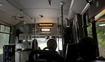 Inside of a bus with a sign glowing "stop requested"