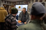 Monte Mensing, owner of Monte’s Coins and More, looks through silver rounds brought in by customers to the Stayton, Ore., shop on Jan. 14, 2026.