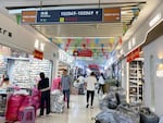 People walk through a building in Yiwu International Trade City, a massive wholesale market in Yiwu, China, where millions of Chinese-made items are sold.