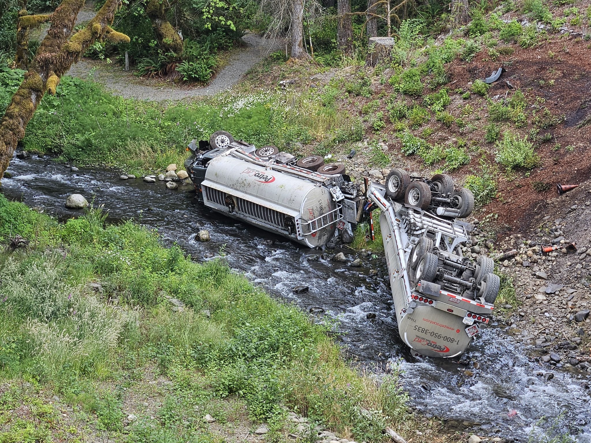 A fuel truck is seen overturned in Indian Creek in the Elwha River watershed after it crashed on Friday, July 18, 2025, near Port Angeles.