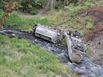 A fuel truck is seen overturned in Indian Creek in the Elwha River watershed after it crashed on Friday, July 18, 2025, near Port Angeles.