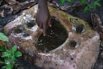 Kansala, Guinea-Bissau (September 24, 2024) - Ibou Sane, a son of Tombon Sana, who is the guardian of the Kansala site, shows a site where warriors would most likely come to bless their swords before going into battle in the now gone city of Kansala, the capital of the Kingdom of Kaabu.