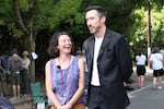 Stefanie Lynch (left) and Daniel Lyman set up for their parallel parking competition in the Kerns neighborhood in Southeast Portland, Ore., on Aug. 30, 2026, while spectators get settled in. The competition started as a joke last year, but this year's turnout well exceeded the first.