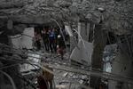 Palestinians examine a destroyed mosque following an Israeli airstrike in Deir al-Balah, on Sunday.