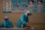 Health workers wearing protective suits collect COVID-19 test samples at a hotel inside the Olympic bubble during the 2022 Winter Paralympics, Monday, March 7, 2022, in the Yanqing district of Beijing. The official global death toll from COVID-19 eclipsed 6 million on Monday — underscoring that the pandemic, now entering its third year, is far from over.
