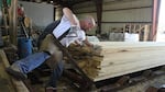 A millworker stacks lumber at the Cave Junction, Ore. Rough & Ready Sawmill in 2013, a few weeks before it closed. State and federal assistance allowed the mill to reopen for a brief time.