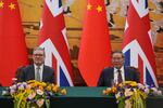 Britain's Prime Minister Keir Starmer, left and Chinese Premier Li Qiang attends a signing ceremony held at the Great Hall of the People in Beijing, China, Thursday, Jan. 29