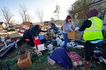 Volunteers help salvage possessions from a destroyed home in the aftermath of tornadoes.