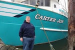 Fisherman Nick Edwards stands proudly in front of his 80ft trawler named, "Carter Jon" at the Charleston Marina in Coos Bay on Dec. 7, 2023. Edwards, who commercially fishes Dungeness crab and pink cocktail shrimp, is working on learning more about the draft wind areas for the potential of floating offshore wind.