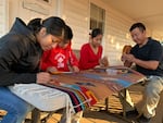 Cinthya, David, Laura and Francisco Bautista put finishing touches on a hand woven tapestry.