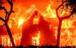 A home is engulfed in flames during the Eaton fire in Southern California in January 2025. Multiple wildfires are raging across the Los Angeles region. Climate change probably made the conditions for those fires more likely.