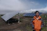 Lexi Crawford stands next to a 10 Killowat array of panels in one of Walker Brothers' fields. 