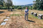 Pacific University archivist Eva Guggemos stands in the Forest View Cemetery in Forest Grove, Ore., in August 2021. At least two Indigenous children who attended the Forest Grove Indian Training School in the 1880s are believed to be buried here in unmarked graves.