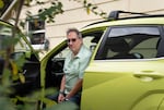 Kip Silverman poses for a portrait in his car. Silverman, who purchased an electric car in 2024, said he has since had trouble finding ways to quickly and reliably charge his car outside of home.
