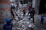 Palestinians survey the destruction after an Israeli strike in Rafah on Jan. 17.