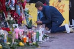 Nathan Williams, a University of New Orleans student, lights a candle at memorial on Bourbon Street for the victims of a deadly truck attack on New Year's Day in New Orleans, Friday, Jan. 3, 2025. (AP Photo/Gerald Herbert)