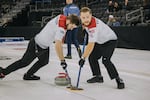Luc Violette, on the right, and Ben Richardson, sweep in front of a throw during a curling competition with Team USA. The two Seattle curlers will be part of a team representing the U.S. at the upcoming Olympics in Italy.