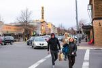 Pedestrians cross a street in downtown Bend, Oregon, on Friday, March 17, 2017. Growth, development and changing traffic patterns have prompted city officials to reduce speed limits on several key arteries around the city. 