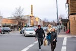 Pedestrians cross a street in downtown Bend, Oregon, on Friday, March 17, 2017. Growth, development and changing traffic patterns have prompted city officials to reduce speed limits on several key arteries around the city. 