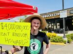 Starbucks barista Ian Meagher has worked for the company for four years. He is also a union organizer. The sign he holds references Starbucks CEO Howard Shultz's reported worth of $4 billion.