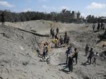 Palestinians search for bodies and survivors in a site hit by an Israeli bombardment on Khan Younis, southern Gaza Strip, Saturday, July 13, 2024  in which the Israeli military claim they killed the head of Hamas' military wing, Mohammed Deif.