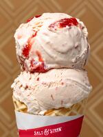 A cone full of Salt & Straw's Strawberry Honey Balsamic with Black Pepper ice cream.