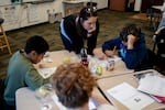 Julie Schaffner helps a student in her fifth grade class at Wascher Elementary School in Lafayette, Ore., on Wednesday, Oct. 15, 2025.