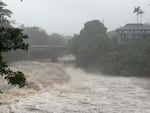 A view of the rising water levels at the Wainaku Street Bridge in Hilo on the Big Island of Hawaii, Saturday, Aug. 15, 2026.