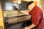 Michael Bryant tunes an old player piano that has had the player removed. “I remember hearing a roll by Rachmaninoff,” Bryant said. “That he had actually been the guy who recorded it at the factory. And when it got played, you thought you were seeing Rachmaninoff on the bench. You couldn’t imagine that it wasn’t him.”