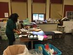 Migrant Education Program Coordinator Teresa Rule organizes paperwork in the Rigler Elementary School office, as part of her job supervising summer classes for migrant and low-income children.