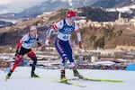 Novie McCabe of the United States and Patricija Eiduka of Latvia, left, compete in the cross country skiing women's 10km + 10km skiathlon at the 2026 Winter Olympics, in Tesero, Italy, Saturday, Feb. 7, 2026.