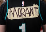 Portland Trail Blazers guard Ja Morant’s name is drawn onto tape covering the name of a past Blazers player who wore the number one.