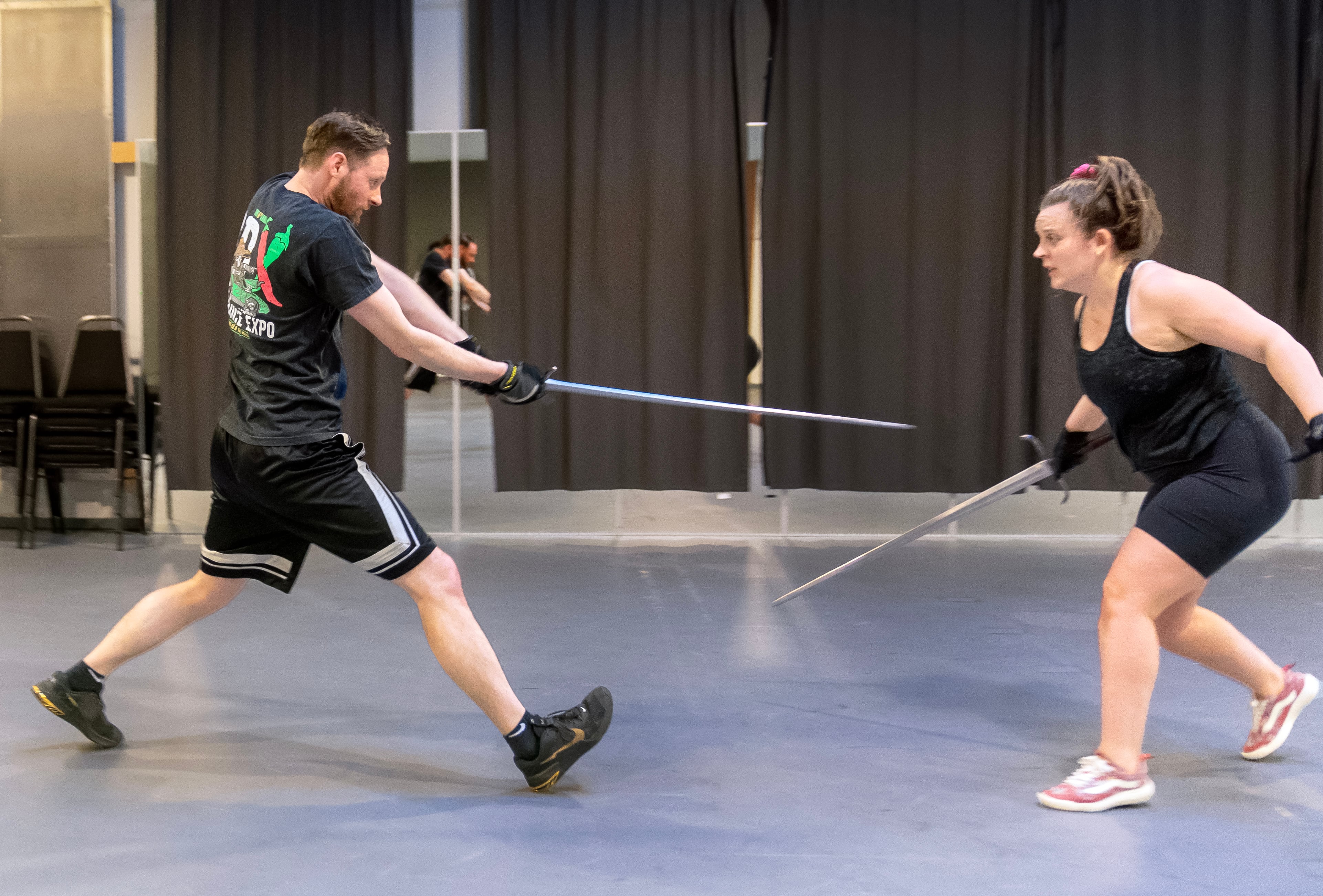 Adam Mun-Van Noy, left, rehearses a scene with Jacquelle Davis during a theatrical combat workshop at the Portland Center Stage in Portland, Ore., March 19, 2024.