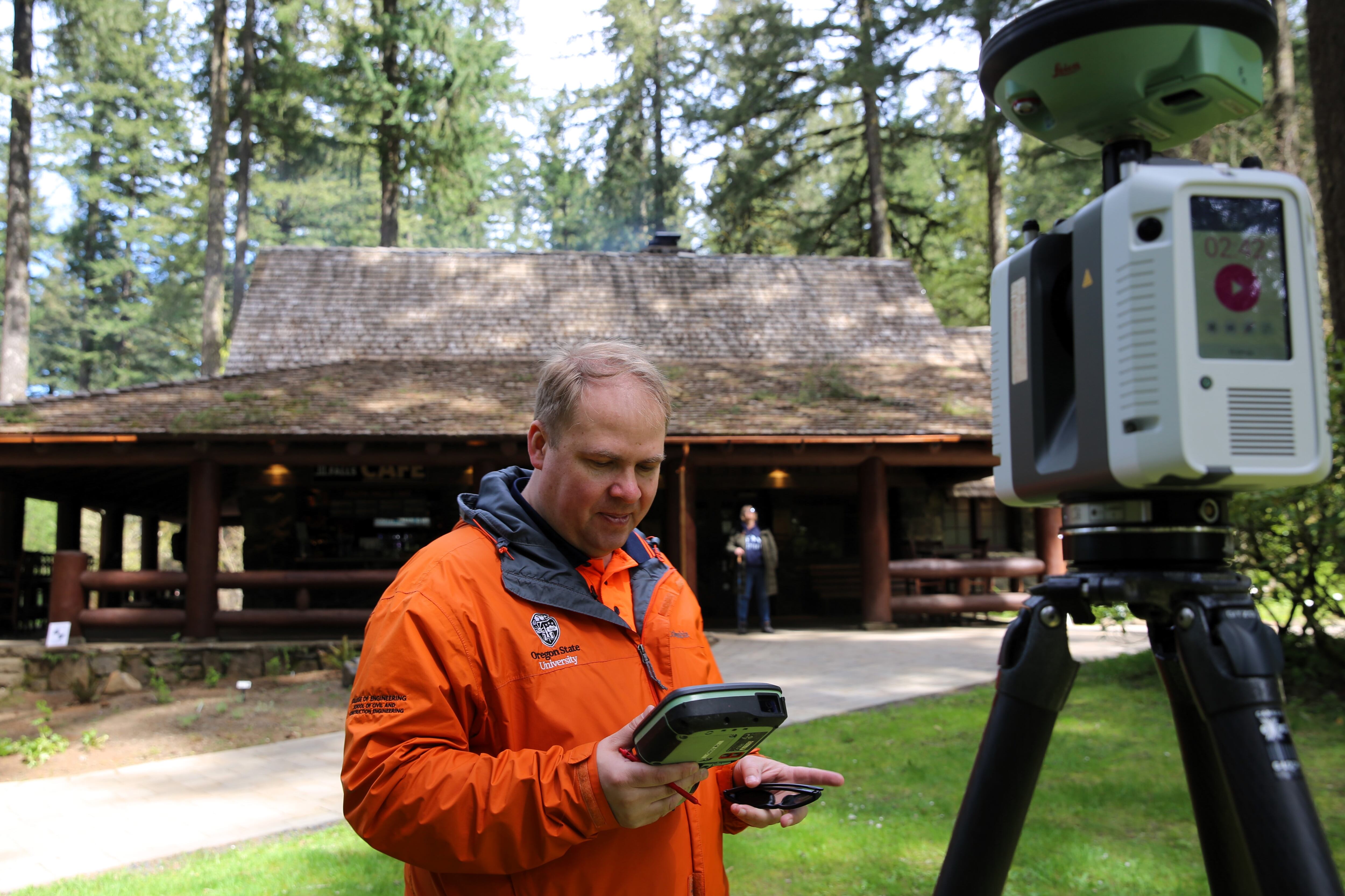 OSU Professor Michael Olsen uses a laser scanner to make a three-dimensional map of Silver Falls Lodge at Silver Falls State Park.