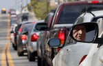 A motorist, who said he had been waiting in line for two hours, waits with others to receive food boxes this week at a large-scale drive-through distribution in City of Industry, California.