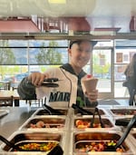 Asher Niles, 9, of Yakima, Wash., grabs frozen yogurt toppings after he competed on MasterChef Junior. The day before, Asher threw out the first pitch at a Seattle Mariners' game and is sporting a custom jersey the team made him.