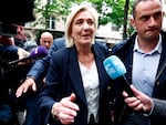 Marine Le Pen, head of the French far-right National Rally party parliamentary group, is surrounded by journalists as she arrives at party headquarters in Paris, the day after French far right win in France's European Parliament elections and the announcement of early legislative elections in France, on June 10.