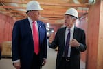 President Trump and Federal Reserve chairman Jerome Powell, wearing construction hard hats, tour the Fed's headquarters renovation last summer. 