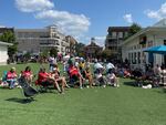 Residents relax on the town green in Alpharetta, Ga., an upscale city just outside Atlanta on Sept. 17, 2022.