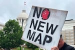 A demonstrator holds up a sign outside the Alabama Statehouse in Montgomery on Thursday.