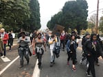 Teressa Raiford marches with fellow protesters to Portland Mayor Charlie Hales' home.