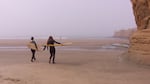 Leslie Palotas, left, and Kelly Potts, right, go for an early morning surf before class.