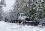 A plow works W. Burnside Ave. in Portland, April 11, 2022. The snowfall amount varied widely across the metro area.