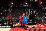 Staff clean up streamers after the Portland Trail Blazers season opening win over the Phoenix Suns.
