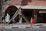 Children walk past damage from the devastating earthquake in Amizmiz, Morocco, on Sept. 14.