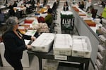 An election worker moves mail-in ballots to be organized for tabulation at the Los Angeles County Ballot Processing Center during California's state primary election in the City of Industry, California, on June 2, 2026.