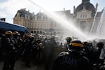 Riot police use a water cannon as they face students during a protest against under-resourced schools, in Rennes, western France, Tuesday, Oct. 6, 2026.